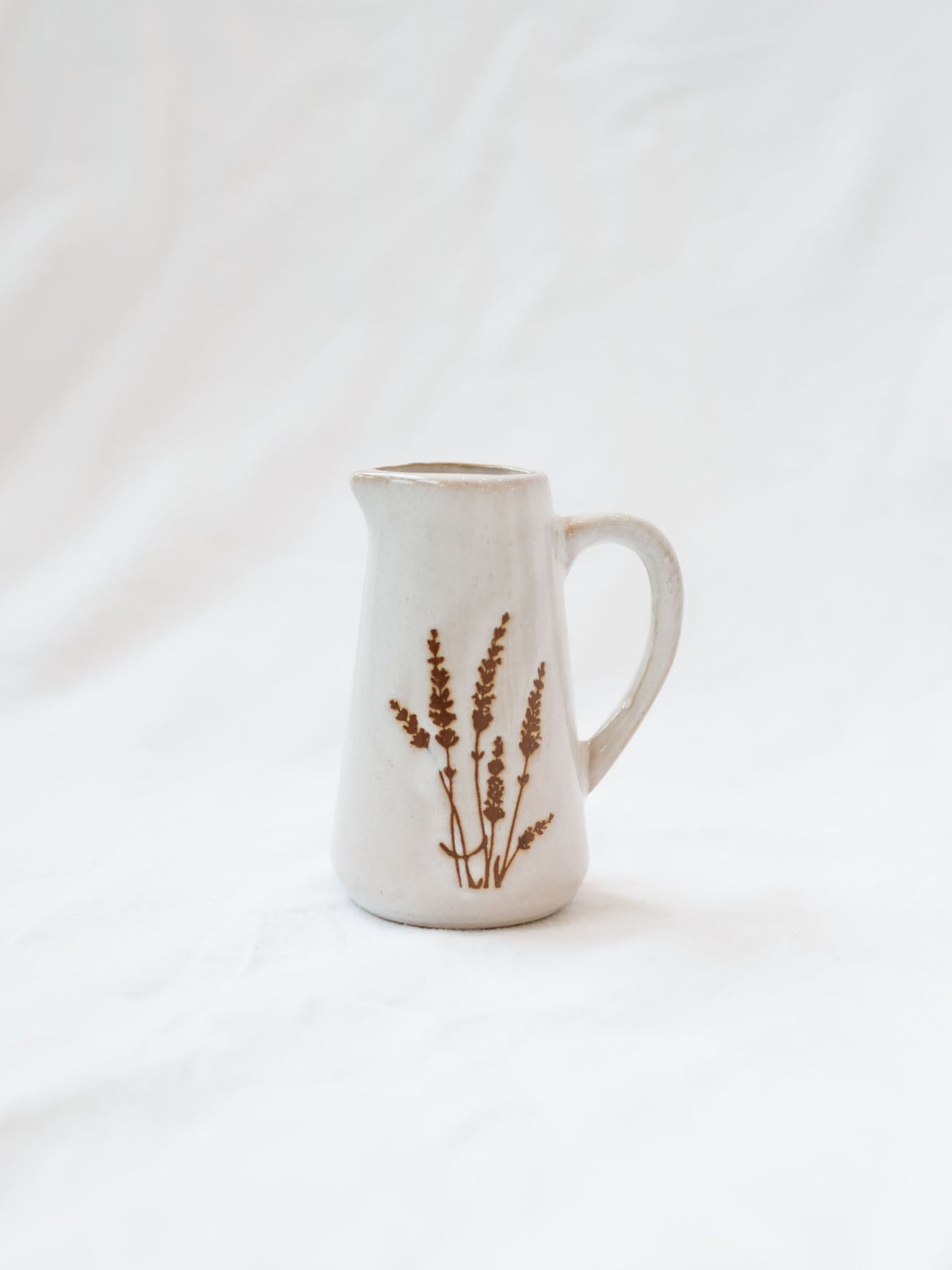 Style 3 of the mini floral pitcher. Set up against a white linen backdrop. 
