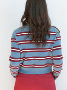 Model wearing long sleeve full button down striped cardigan.