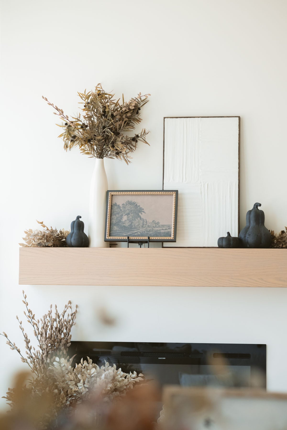 Tan florist stem styled on bench by mantel with other fall stems.