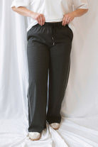 Jude Waistband with String Check Woven Long Pants in black featuring a classic check pattern and relaxed styling.