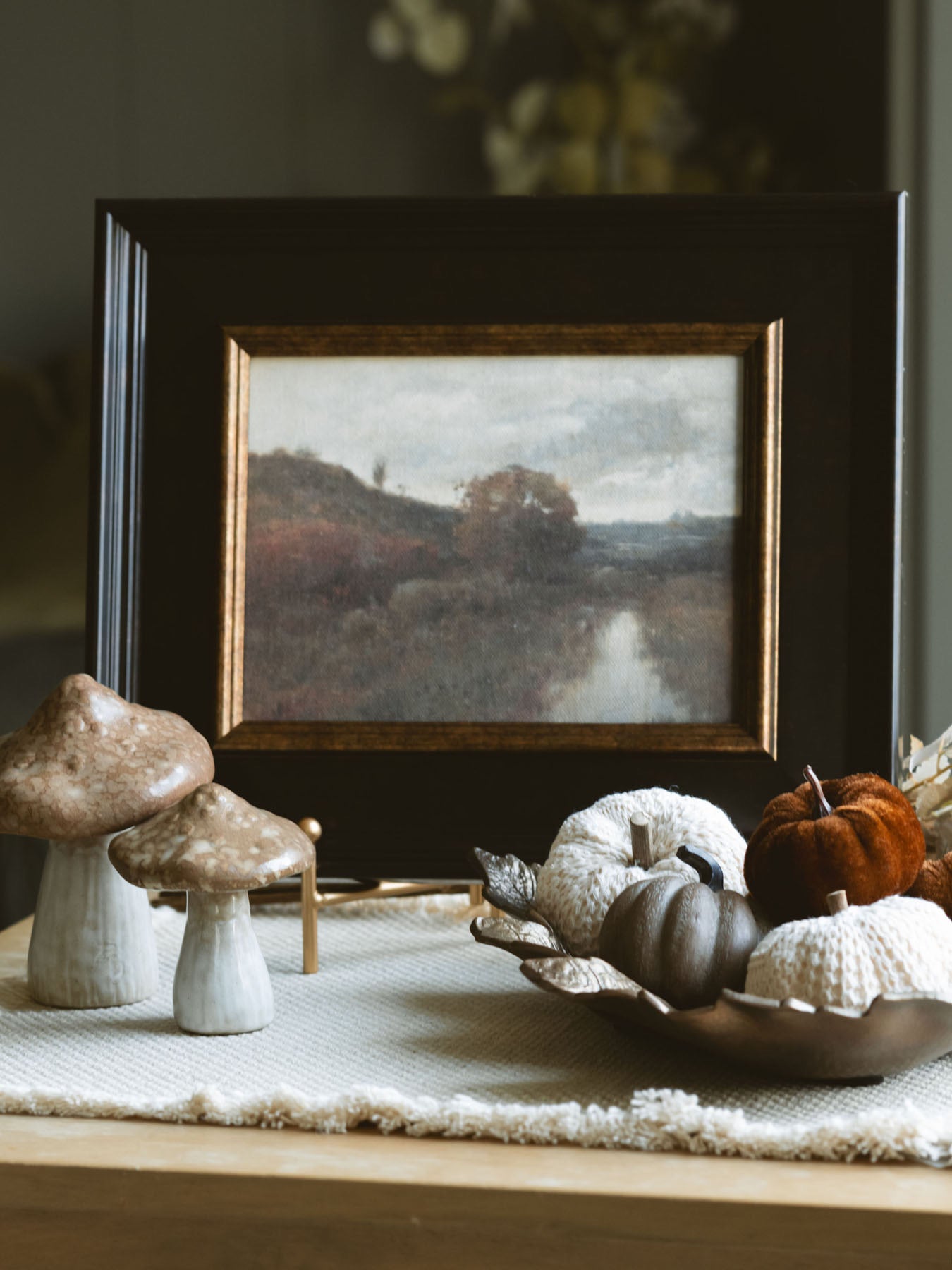 Small woodgrain brown pumpkin styled with other small pumpkins in our antique gold leaf bowl 