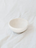 Large size of the marble bowls sitting in front of a white linen backdrop. 