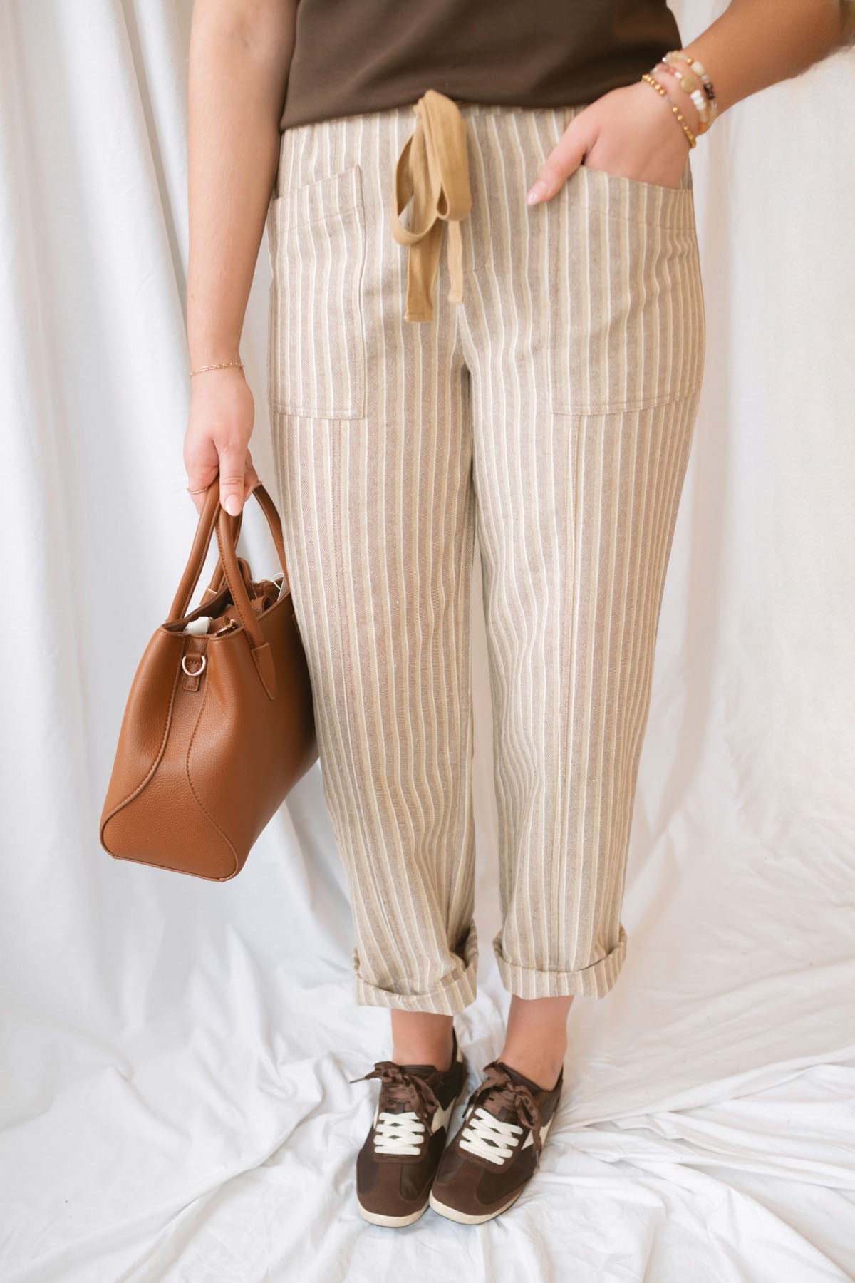 Steph Striped Wide Leg Drawstring Pants in Warm Sand Stripe featuring a relaxed silhouette and neutral striped pattern.