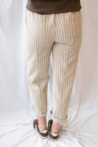 Steph Striped Wide Leg Drawstring Pants in Warm Sand Stripe featuring a relaxed silhouette and neutral striped pattern.