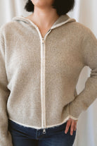 Ginger mocha knit hooded cardigan with contrast trim, long sleeves, and a front zip closure.
