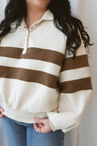 Lottie rugby-inspired pullover featuring horizontal cream and camel stripes.
