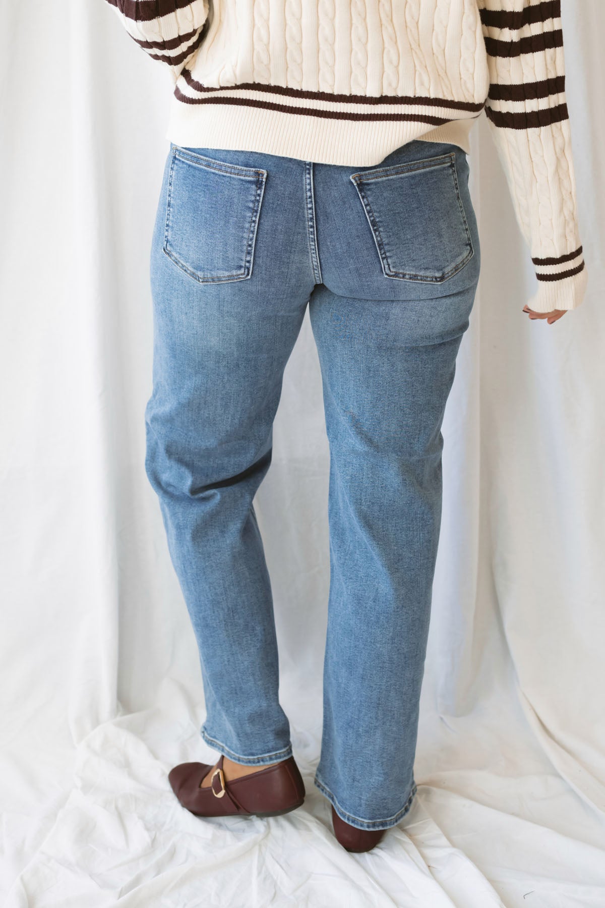 Devan full length straight leg jeans in medium denim with a classic five-pocket design and versatile straight-leg silhouette.