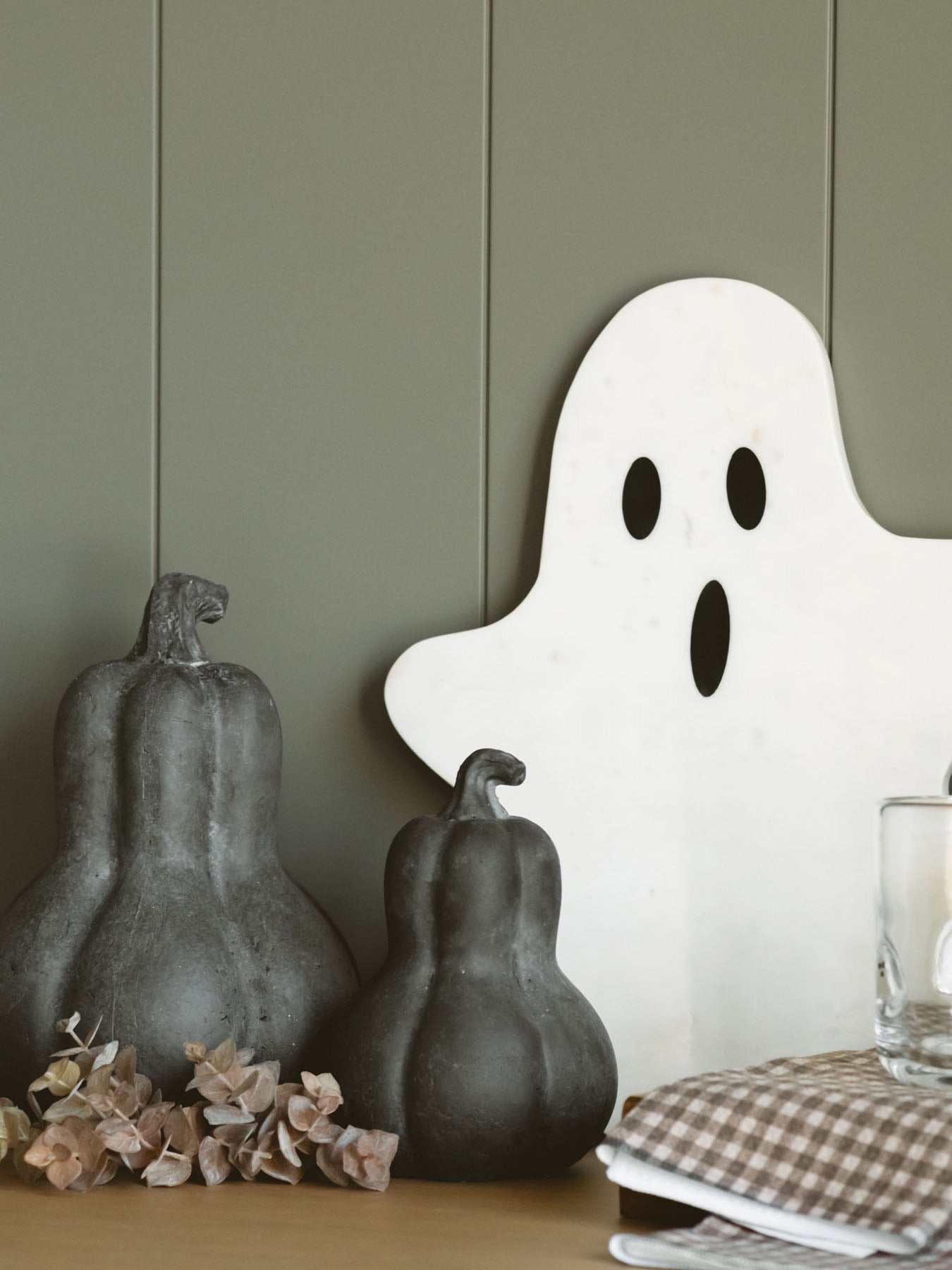 The medium and large gourds are styled together with a marble ghost shaped board and a small eucalyptus style sprig. 
