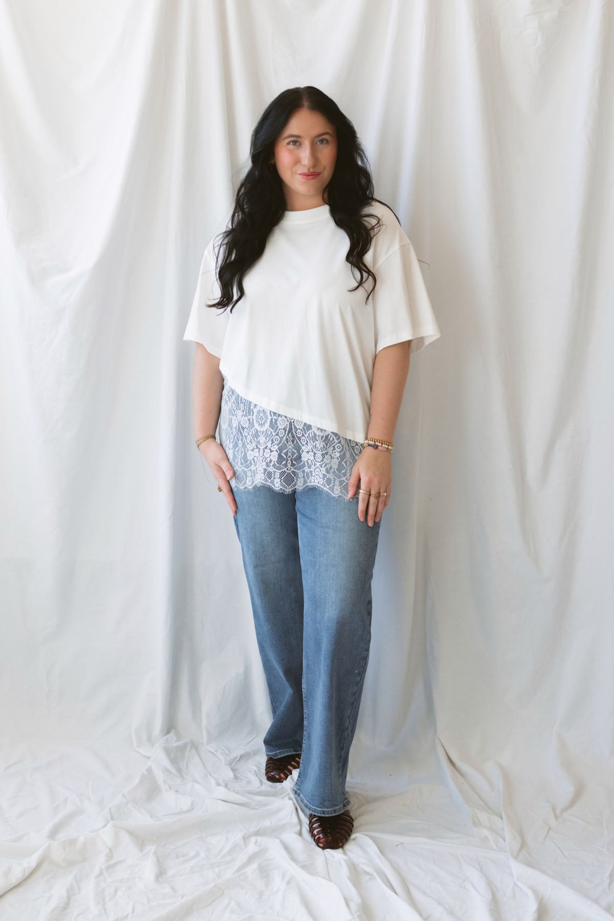Jane ivory T-shirt featuring delicate floral lace trim and an asymmetrical design.