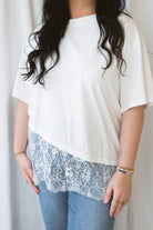 Jane ivory T-shirt featuring delicate floral lace trim and an asymmetrical design.