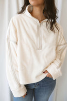 Fiona ivory half zip fleece pullover with contrasting trim details and long sleeves.