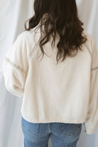 Fiona ivory half zip fleece pullover with contrasting trim details and long sleeves.