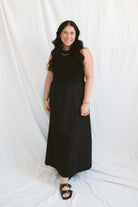 Model wearing the sleeveless piping knit contrast detail midi dress