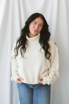 Maisie alpaca waffle sweatshirt with a cozy funnel neckline and long sleeves.