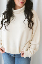 Maisie alpaca waffle sweatshirt with a cozy funnel neckline and long sleeves.
