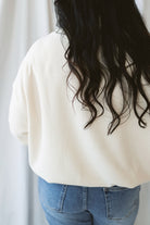 Maisie alpaca waffle sweatshirt with a cozy funnel neckline and long sleeves.