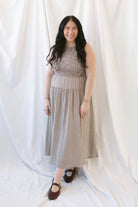 Willow brown gingham sleeveless midi dress with a smocked bodice and tiered skirt.