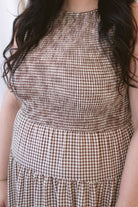 Willow brown gingham sleeveless midi dress with a smocked bodice and tiered skirt.