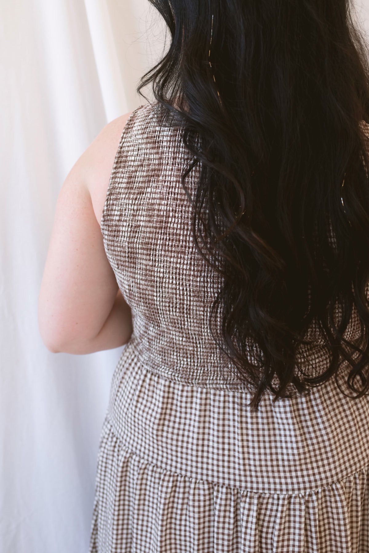 Willow brown gingham sleeveless midi dress with a smocked bodice and tiered skirt.