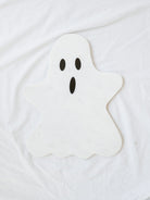 Marble ghost board in white with black details laying on white linen backdrop. 