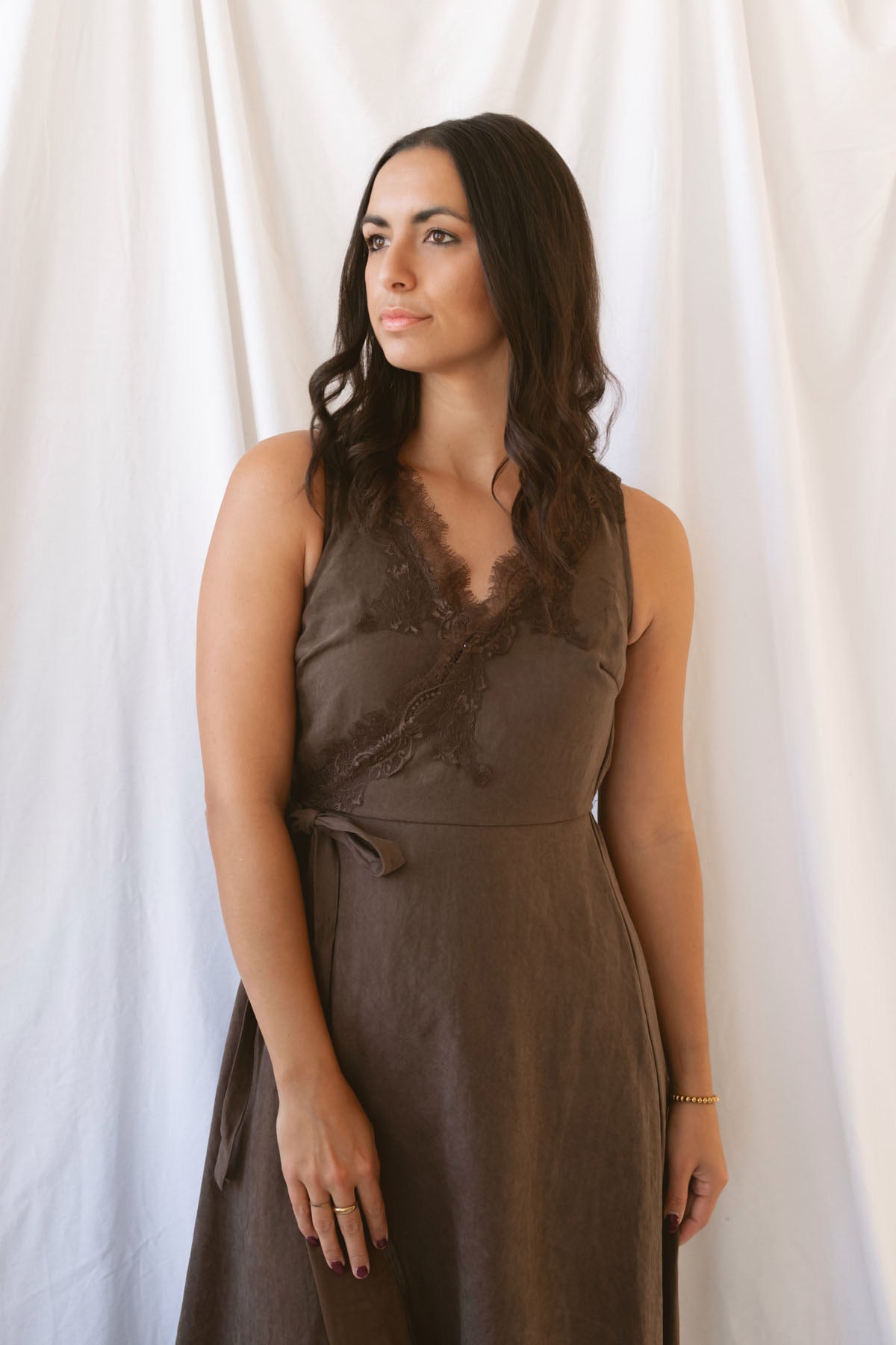 Sadie brown midi dress with a V-neck surplice front, lace trim, and tie waist.