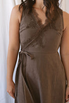 Sadie brown midi dress with a V-neck surplice front, lace trim, and tie waist.