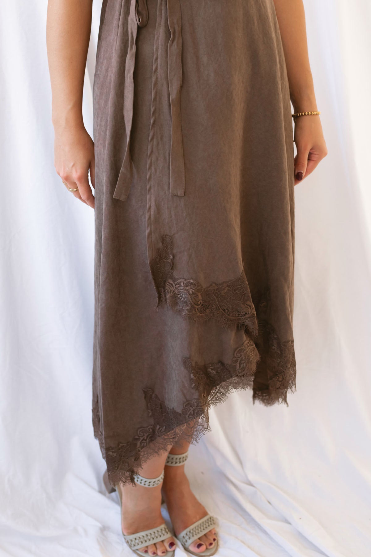 Sadie brown midi dress with a V-neck surplice front, lace trim, and tie waist.