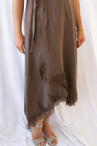 Sadie brown midi dress with a V-neck surplice front, lace trim, and tie waist.