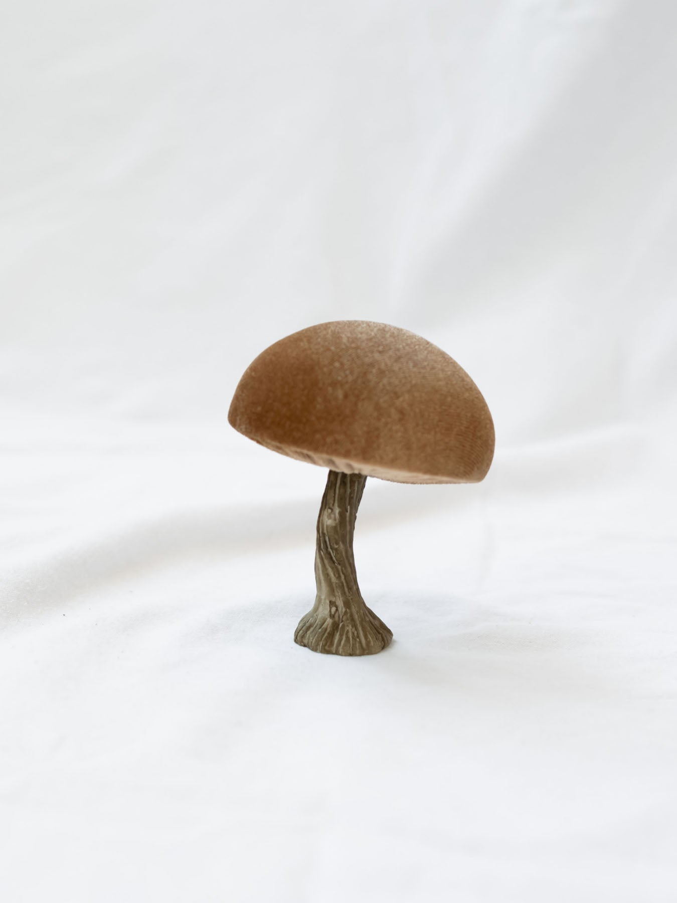 The champange color mushroom set up on a white linen backdrop. 