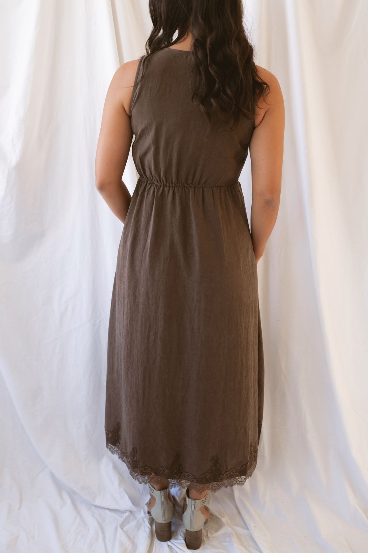 Sadie brown midi dress with a V-neck surplice front, lace trim, and tie waist.