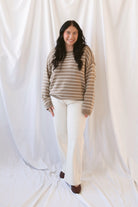 Selena taupe sweater with cream stripes, a relaxed drop shoulder fit, crew neckline, and long sleeves.