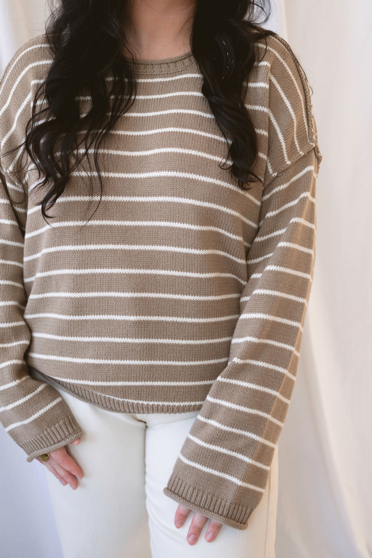 Selena taupe sweater with cream stripes, a relaxed drop shoulder fit, crew neckline, and long sleeves.