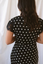 Joanna black polka dot midi dress featuring short sleeves and delicate lace trim detailing.