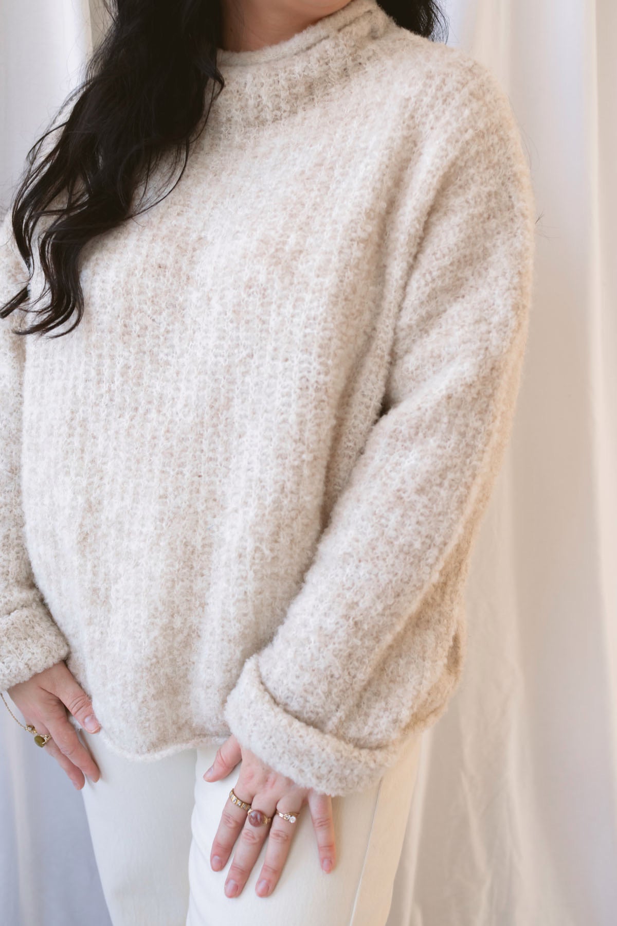 Emily oatmeal fuzzy knit sweater with a raw-edge mock neckline and long sleeves.