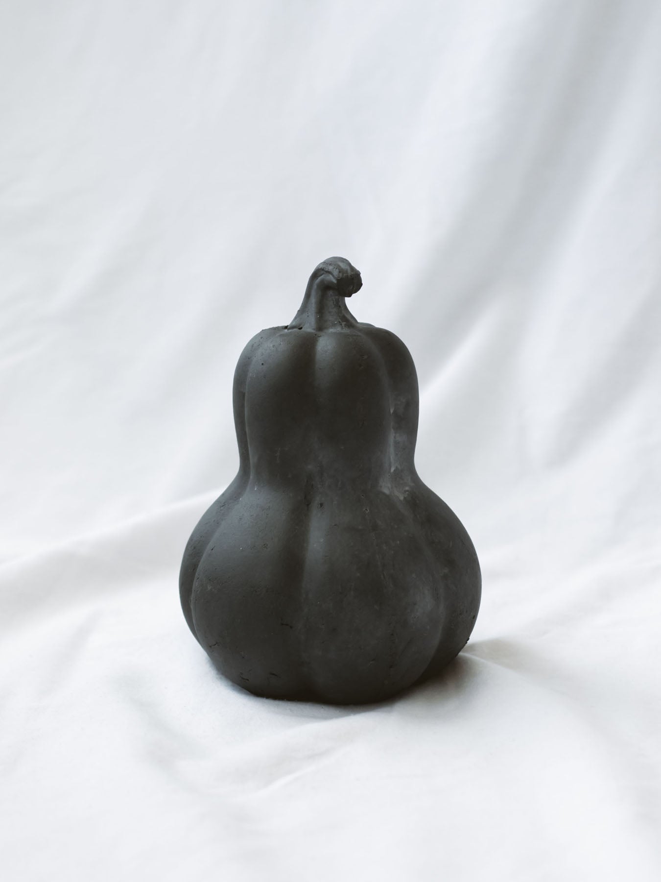 Middle size of the 3 styles sitting on a white linen backdrop. 