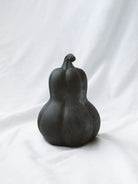 Middle size of the 3 styles sitting on a white linen backdrop. 