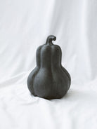 Largest size of the 3 styles sitting on a white linen backdrop. 