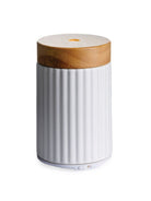 Ultrasonic diffuser with white ceramic base and wood detail top on a white background